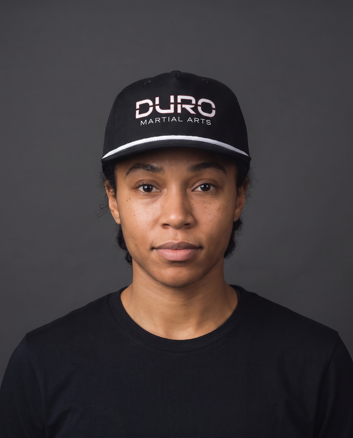 DURO Martial Arts 5-Panel Rope Cap modeled against a charcoal studio background — AI-generated styling image