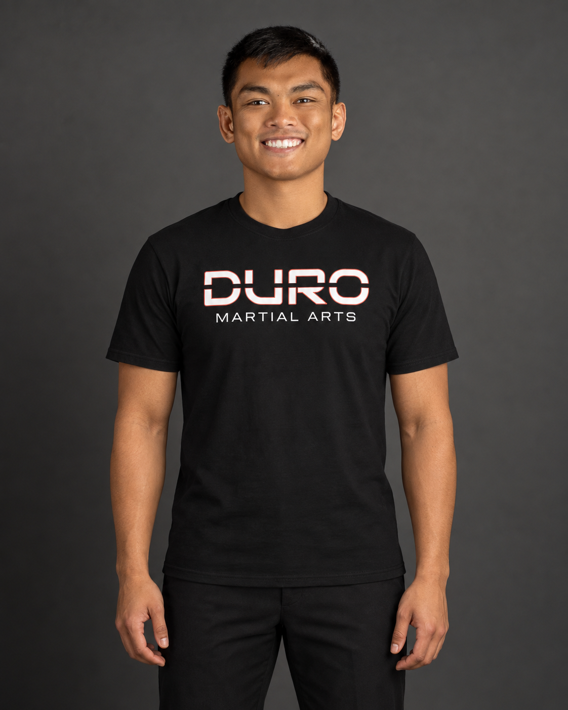 Coach TJ Hernandez modeling the black DURO Martial Arts Everyday Tee — AI-assisted studio image