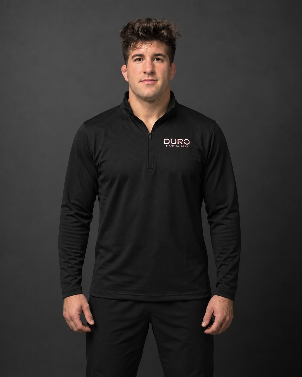 Coach Jordan modeling the black DURO Martial Arts Performance Quarter-Zip — AI-assisted studio photo