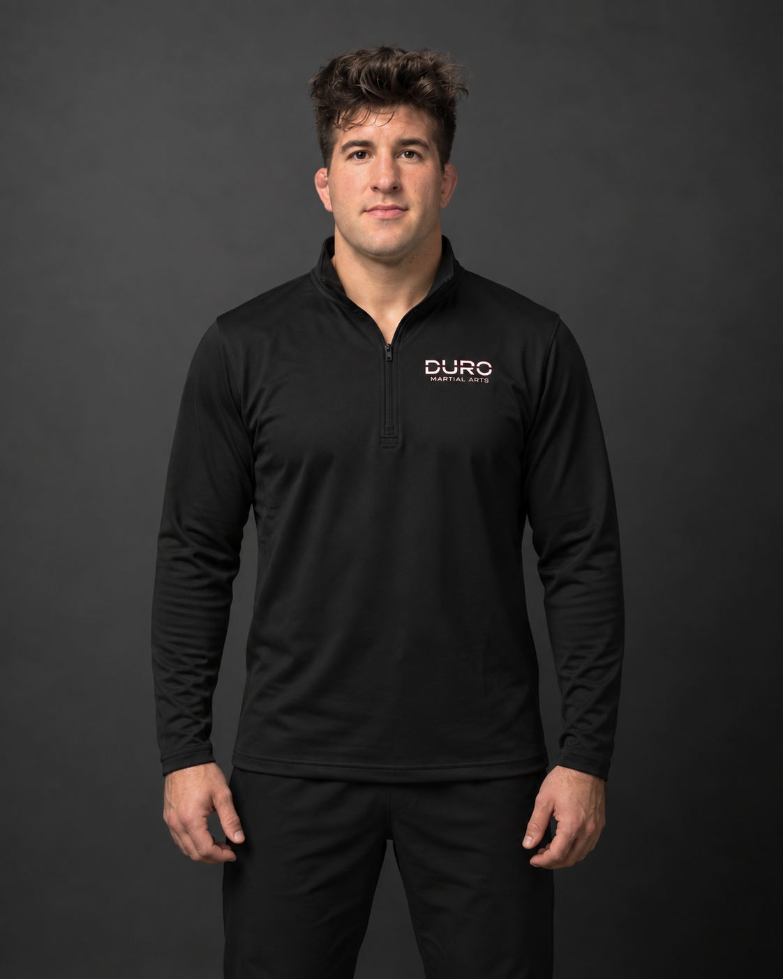 Coach Jordan modeling the black DURO Martial Arts Performance Quarter-Zip — AI-assisted studio photo