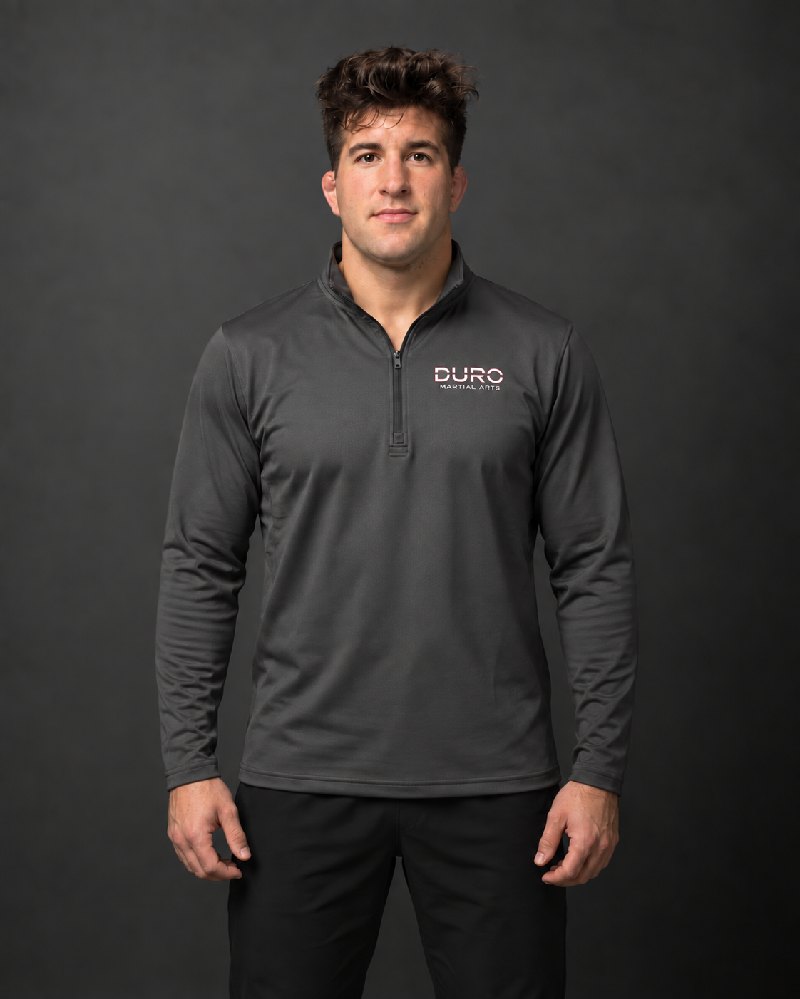 Coach Jordan modeling the iron grey DURO Martial Arts Performance Quarter-Zip — AI-assisted studio photo