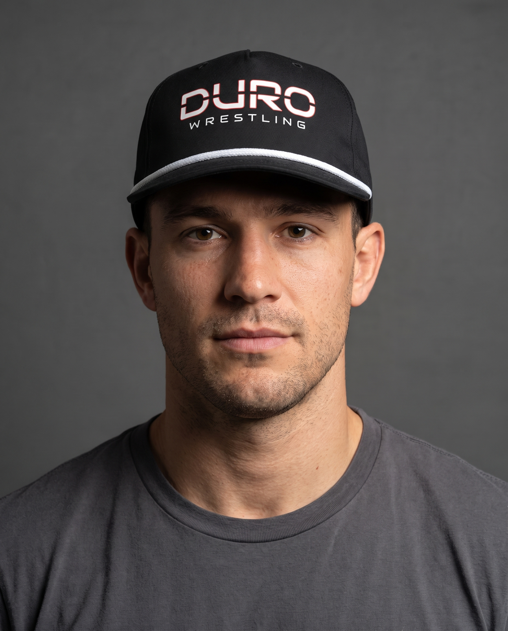 DURO Wrestling 5-Panel Rope Cap modeled against a charcoal studio background — AI-generated styling image