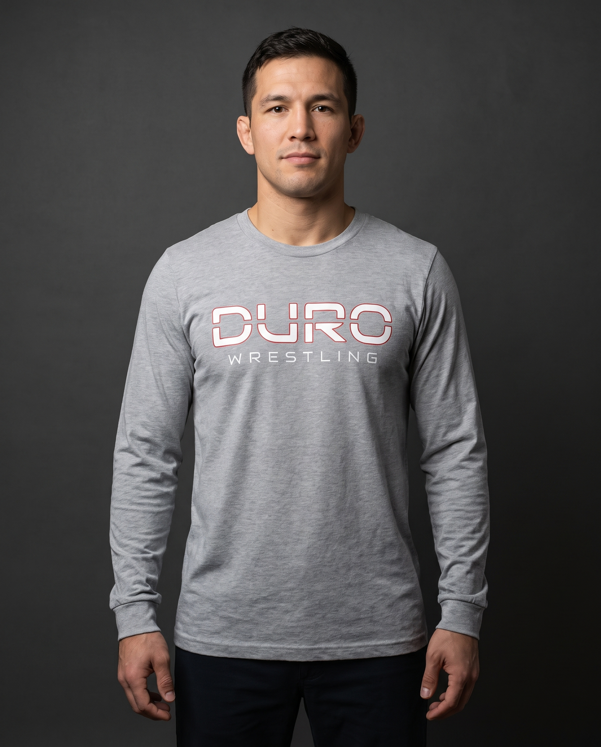DURO Wrestling Everyday Long Sleeve Tee modeled against a charcoal studio background — AI-generated styling image