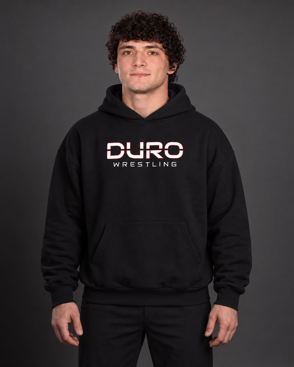 Tanner modeling the black DURO Wrestling Heavyweight Hoodie — AI-assisted studio image