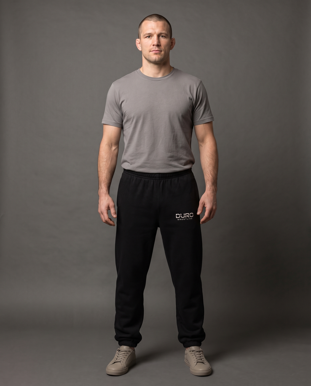 DURO Wrestling Heavyweight Sweatpants modeled against a charcoal studio background — AI-generated styling image