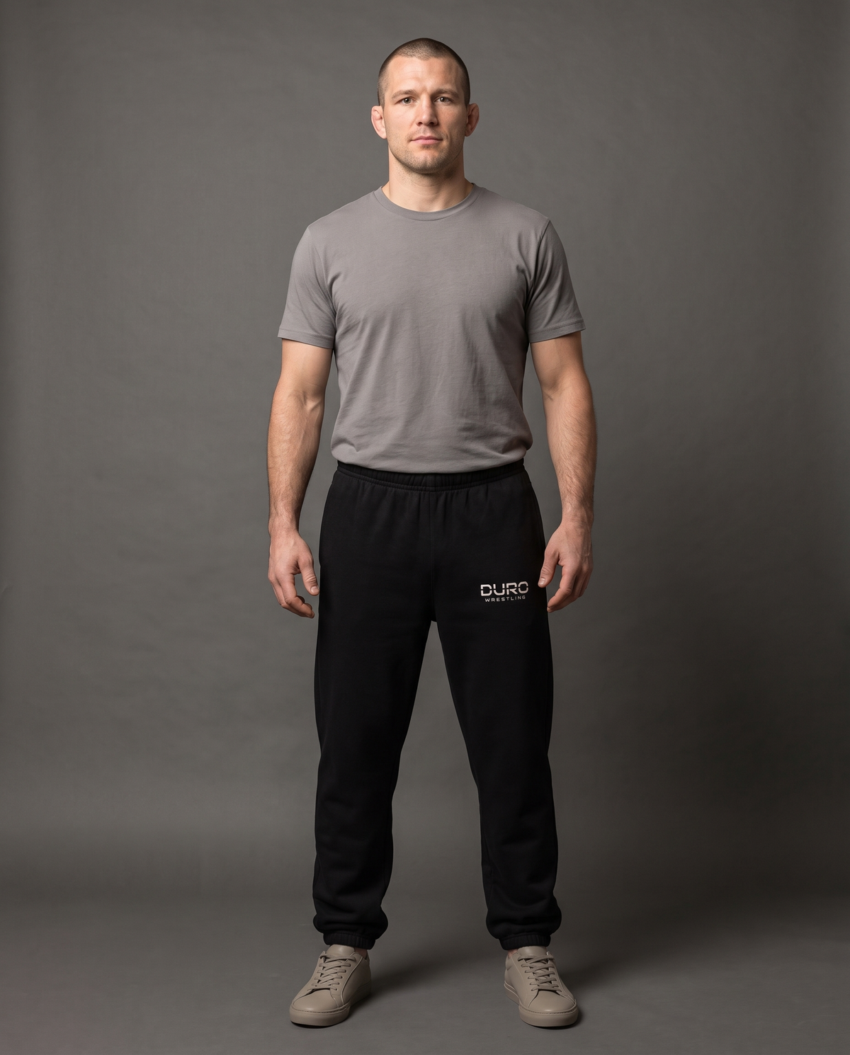 DURO Wrestling Heavyweight Sweatpants modeled against a charcoal studio background — AI-generated styling image