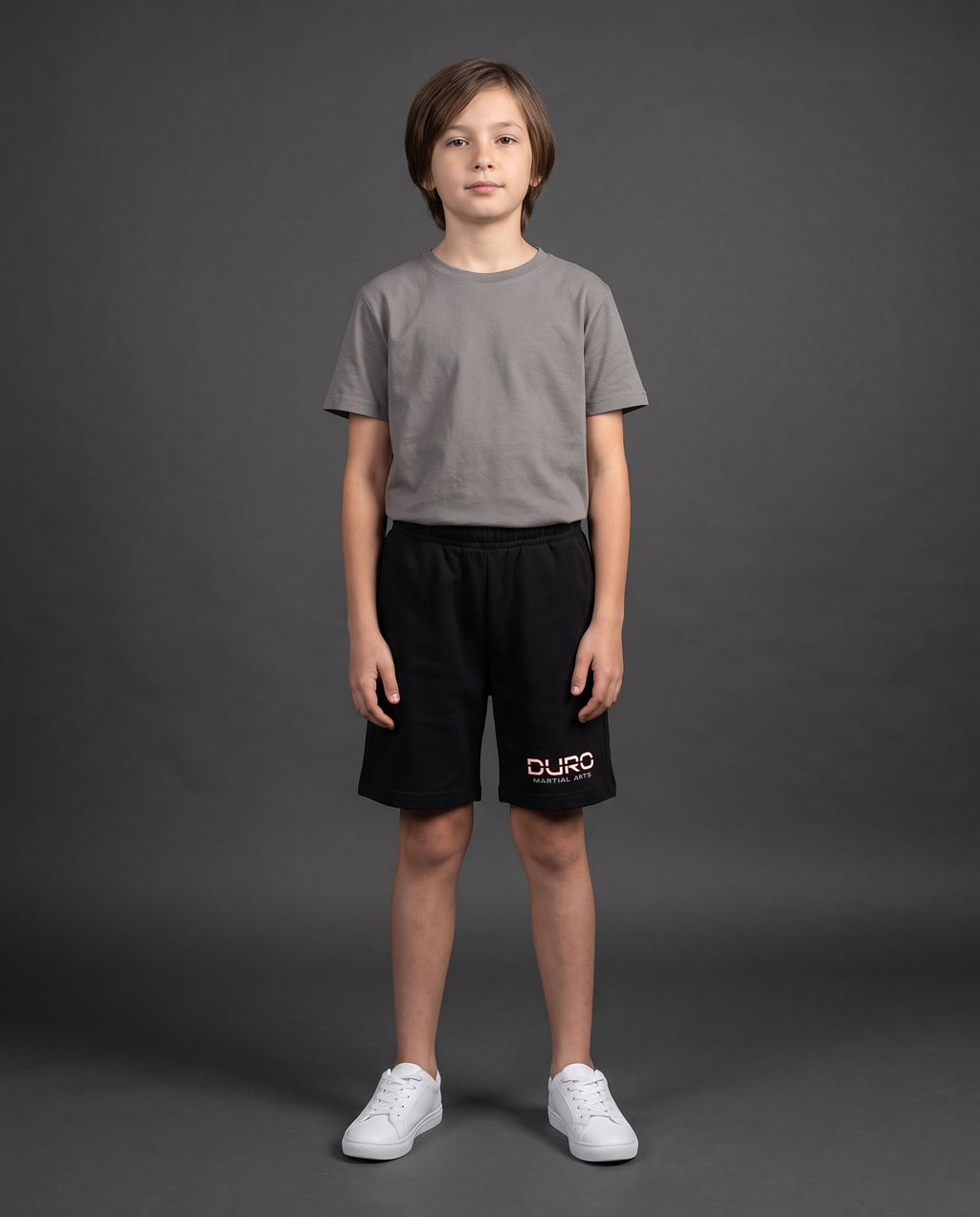 DURO Youth Martial Arts Cotton Shorts modeled against a charcoal studio background — AI-generated styling image