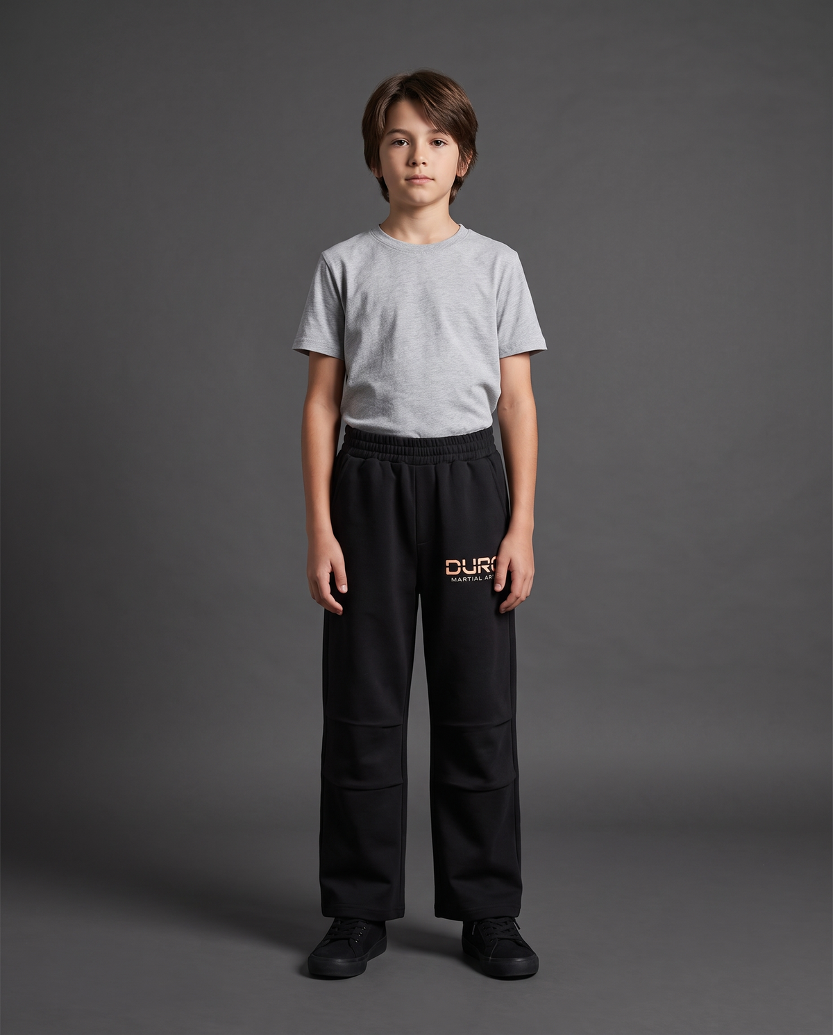 DURO Youth Martial Arts Straight-Leg Sweatpants modeled against a charcoal studio background — AI-generated styling image
