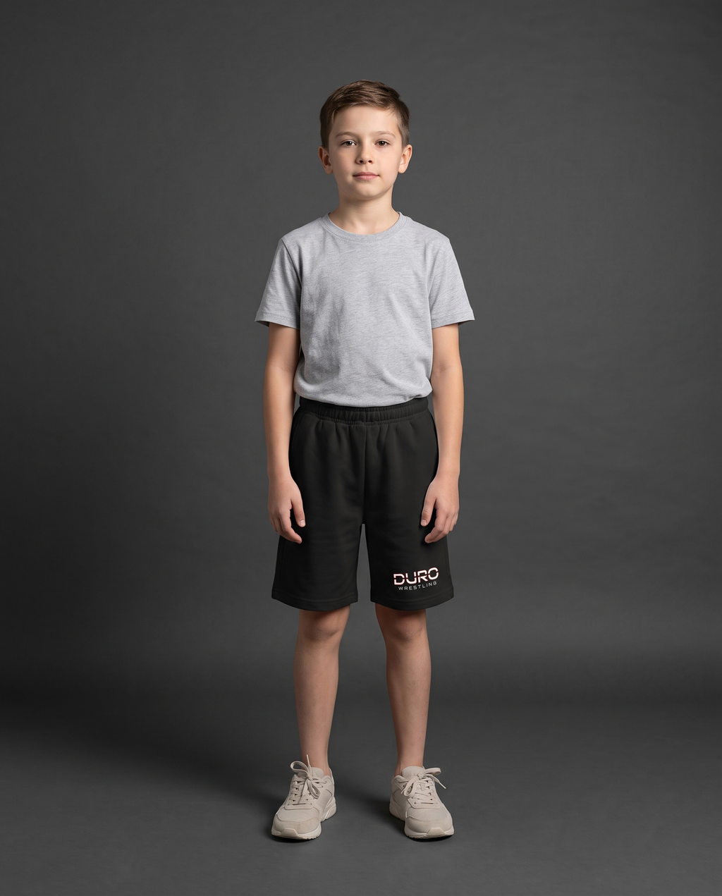 DURO Youth Wrestling Cotton Shorts modeled against a charcoal studio background — AI-generated styling image