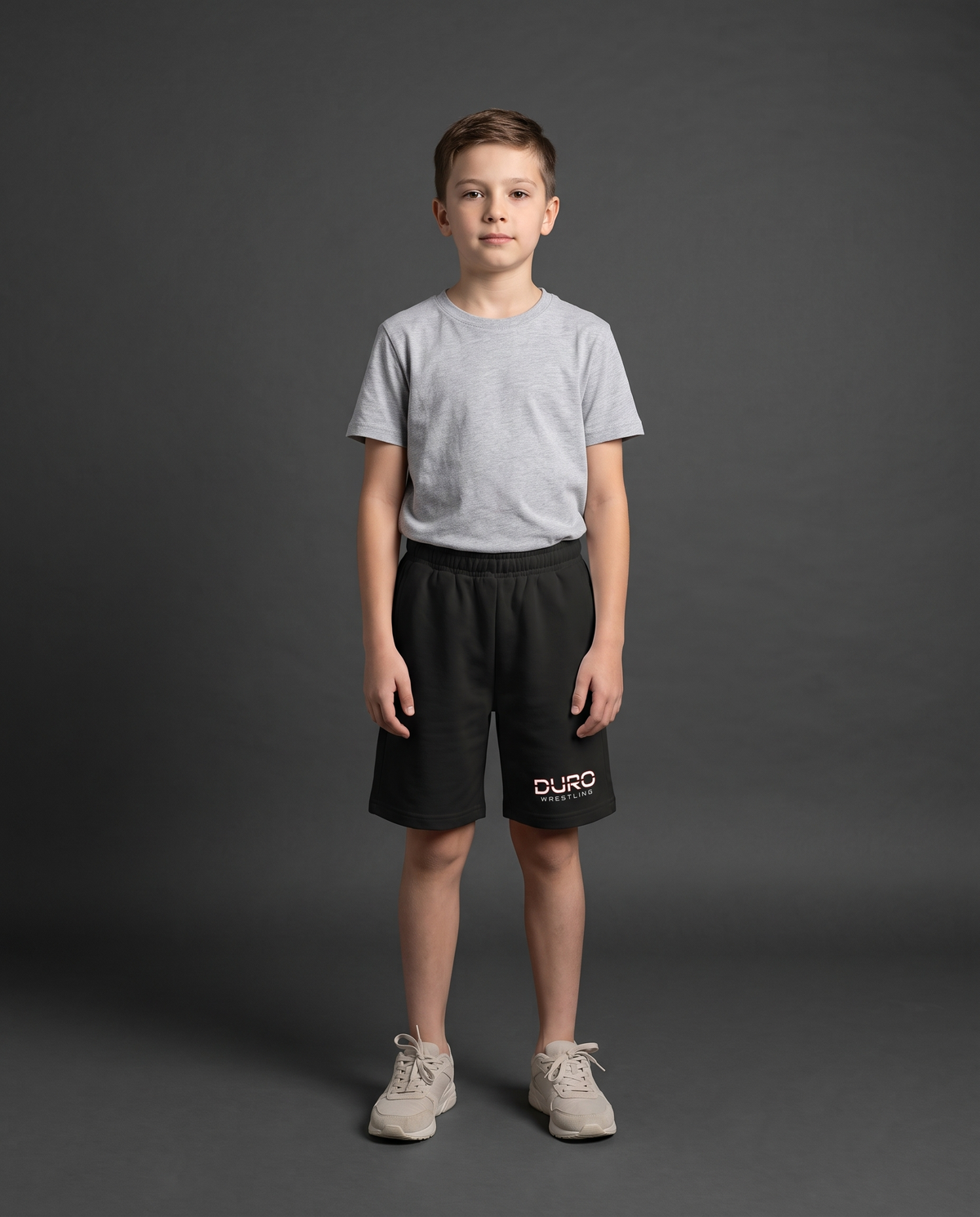 DURO Youth Wrestling Cotton Shorts modeled against a charcoal studio background — AI-generated styling image