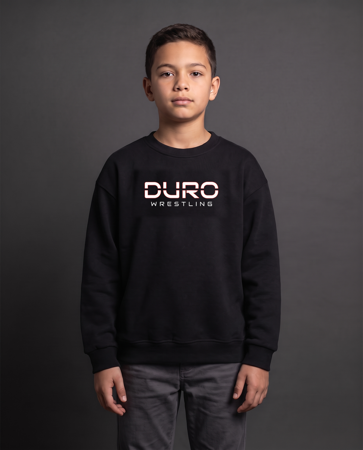 DURO Youth Wrestling Heavyweight Fleece Crewneck modeled against a charcoal studio background — AI-generated styling image