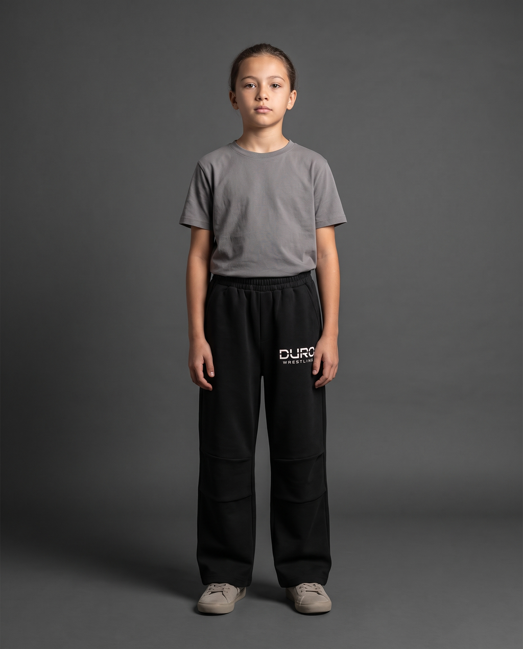 DURO Youth Wrestling Straight-Leg Sweatpants modeled against a charcoal studio background — AI-generated styling image