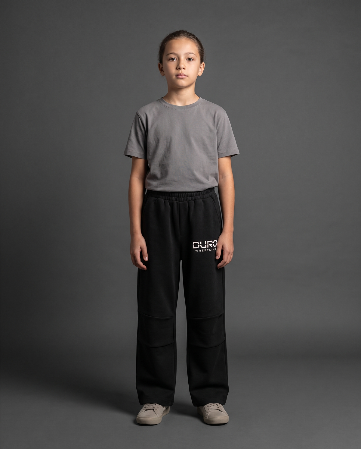 DURO Youth Wrestling Straight-Leg Sweatpants modeled against a charcoal studio background — AI-generated styling image